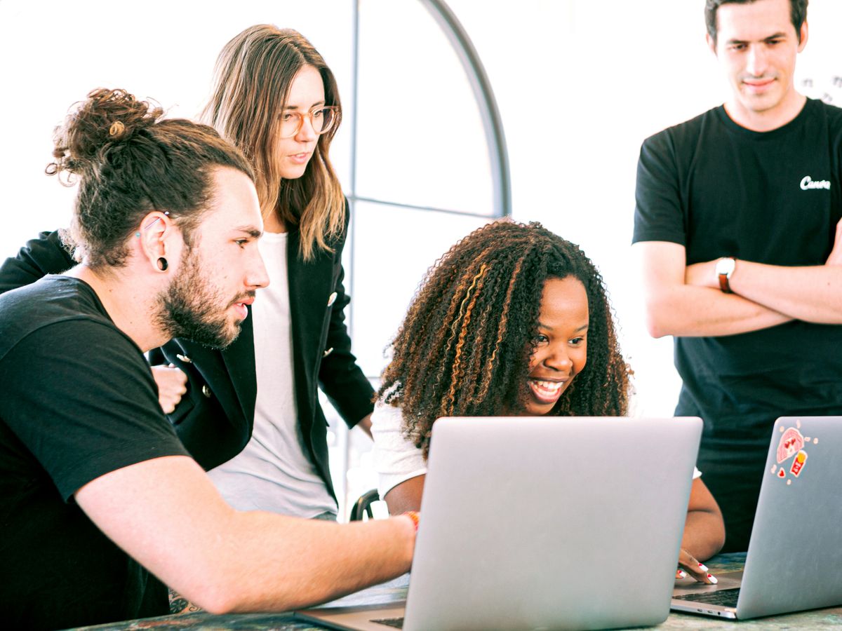 A diverse group of young professionals collaborating in a modern workspace